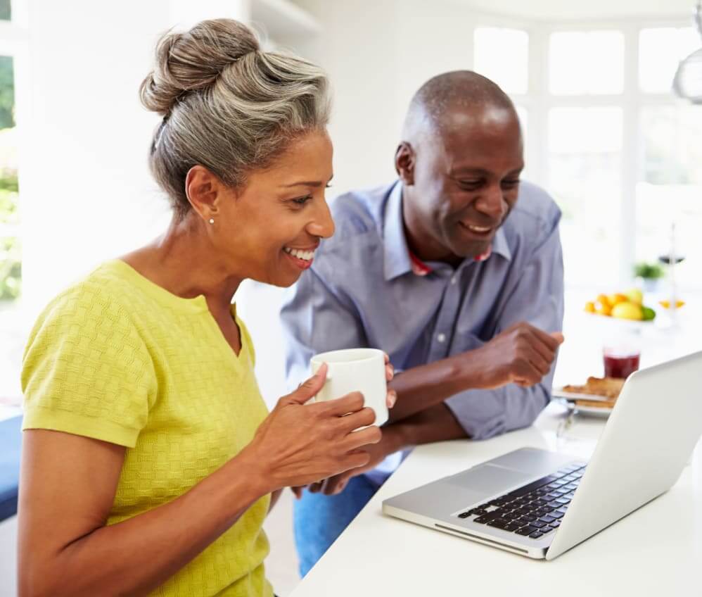 Older couple sharing coffee while exploring options for transitioning from independent living to assisted living in Houston, Texas